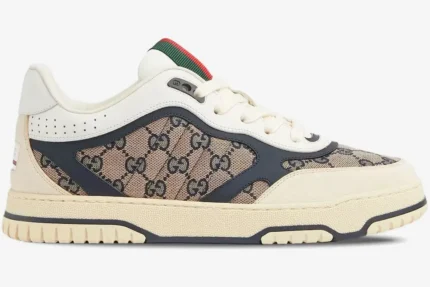 Side profile of a Gucci Re-Web sneaker in beige GG canvas with ivory and blue leather accents. - SKU 787476AADHW9552