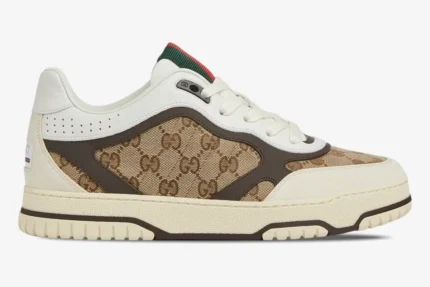 Side profile of Gucci Re-Web Sneaker in beige ebony GG canvas and white leather with brown trim. - SKU 787476AADHW9568