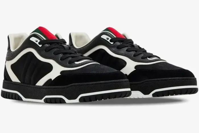 Gucci Re-Web sneakers in black GG canvas and leather, shown from a three-quarter side angle. - SKU 787476AADHW1077