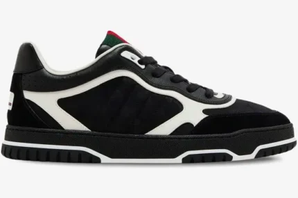 Side profile of a black Gucci Re-Web Sneaker featuring GG canvas, white leather overlays, and a green-red web tongue. - SKU 787476AADHW1077