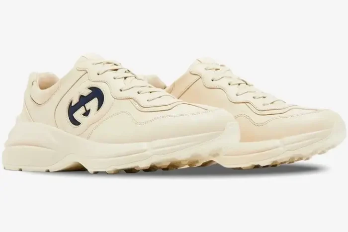 Gucci Rhyton Interlocking G Ivory Blue sneakers shown from a side three-quarter angle on a white background. - SKU 757857UPG709567