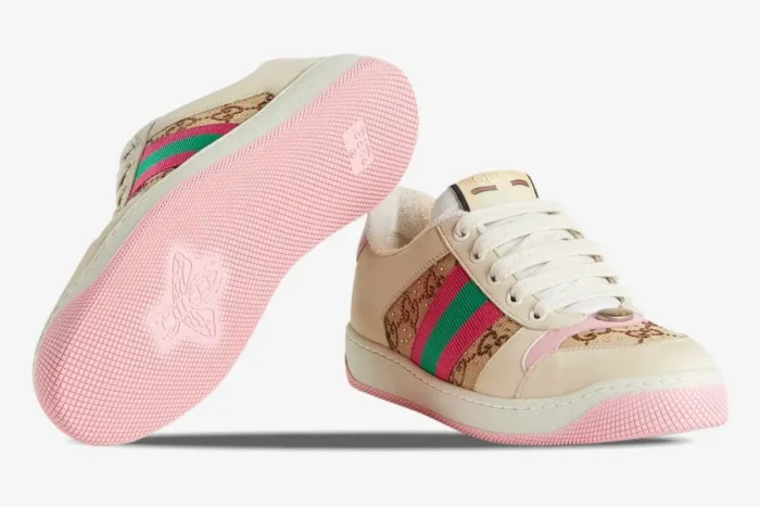 Gucci Screener GG Supreme distressed sneakers in cream and pink, showing side profile and pink bee-embossed sole. - SKU 548950