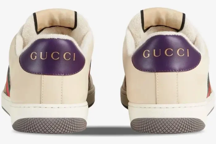 Rear view of Gucci Screener GG Supreme sneakers with vintage purple leather heel tabs and gold logo. - SKU 546551HVKI09765