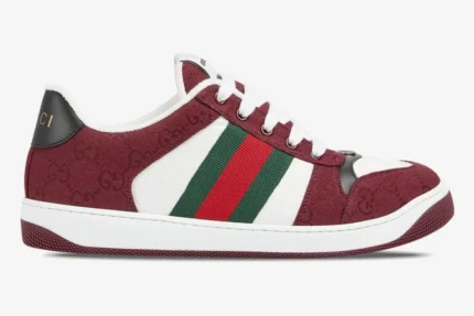 Side profile of a Gucci Screener sneaker in Rosso Ancora GG canvas with green and red web stripe. - SKU 812638FAD7W8542