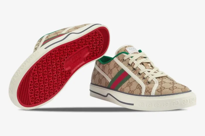 Gucci Tennis 1977 GG Supreme Canvas sneakers in beige, showing side profile and red logo-patterned sole. - SKU 606111HVK209766