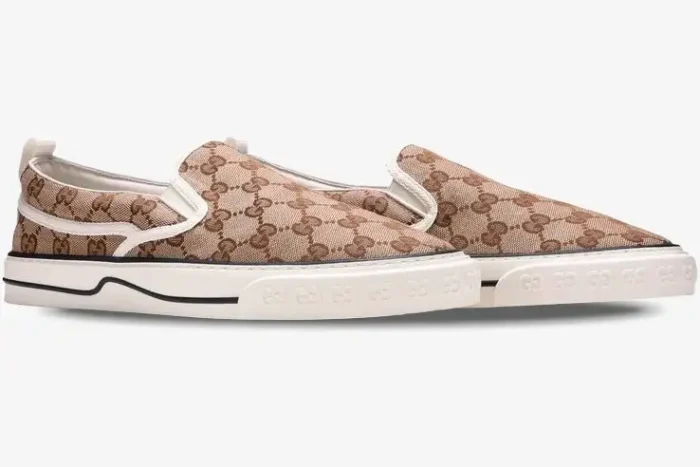 Side view of Gucci Tennis 1977 slip-on sneakers in beige GG Supreme monogram with white rubber soles. - SKU 643489-2HK30-9761