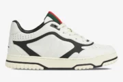 Side view of Gucci Women's Re-Web Sneaker in white and black leather with signature web stripe detail. - SKU 786186AADPM9055