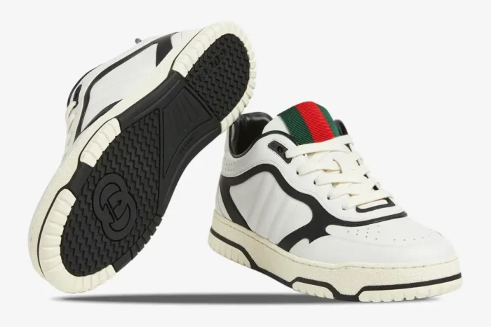 Gucci Women's Re-Web Sneaker in white and black, showing side profile and sole detail. - SKU 786186AADPM9055