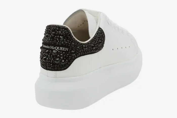 Alexander McQueen white oversized sneaker with black glitter heel tab, rear view perspective. - SKU 666407WIAIJ9581