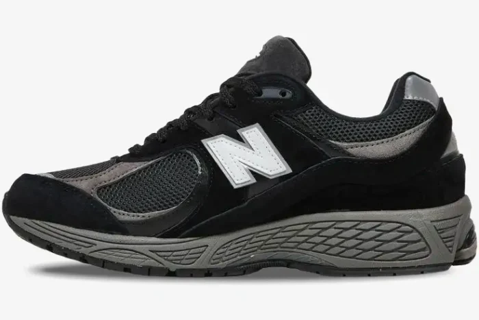 Side profile view of a black and grey New Balance 2002R sneaker with a white logo. - SKU M2002RR1