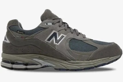 Side profile of New Balance 2002R GORE-TEX sneakers in Castlerock Natural Indigo grey and navy. - SKU M2002RXC