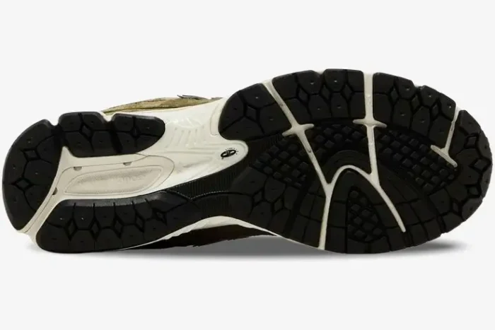 Bottom view of New Balance 2002R Footlocker Exclusive Green sneakers showing black rubber outsole. - SKU M2002RFO