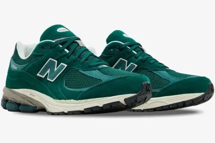 A pair of green suede and mesh New Balance 2002R sneakers shown from a three-quarter angle. - SKU M2002RG