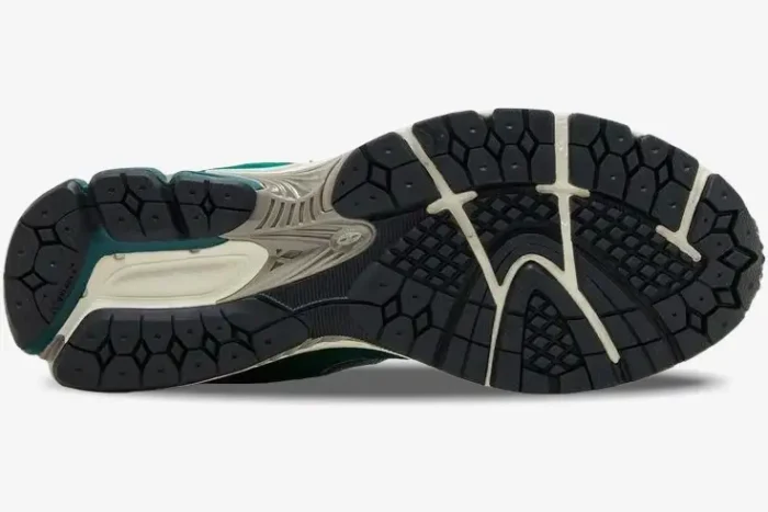 Bottom view of New Balance 2002R Green Suede and Mesh sneakers showing the black and cream outsole tread pattern. - SKU M2002RG