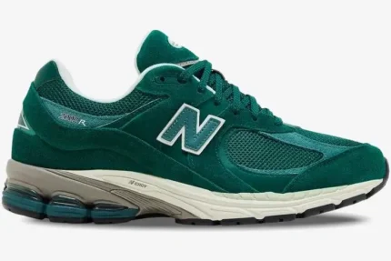 Side view of a New Balance 2002R sneaker featuring green suede and mesh panels with a white N logo. - SKU M2002RG