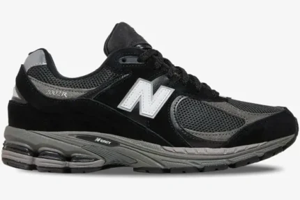 Side view of New Balance 2002R x JD Sports Exclusive 'Black' sneakers featuring black suede and grey mesh. - SKU M2002RR1