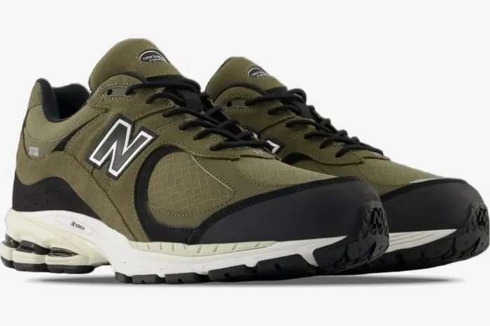 New Balance 2002R Olive Black premium suede sneakers in a three-quarter side view. - SKU M2002RXU