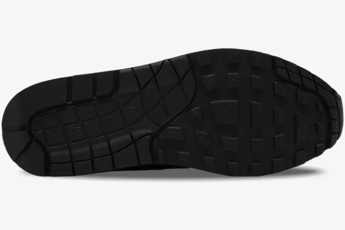 Bottom view of the black rubber outsole on a Nike Air Max 1 '87 SP x Supreme sneaker. - SKU HF8813-001
