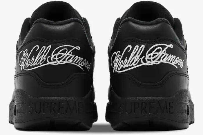 Rear view of black Nike Air Max 1 '87 SP x Supreme sneakers with white 'World Famous' embroidery. - SKU HF8813-001