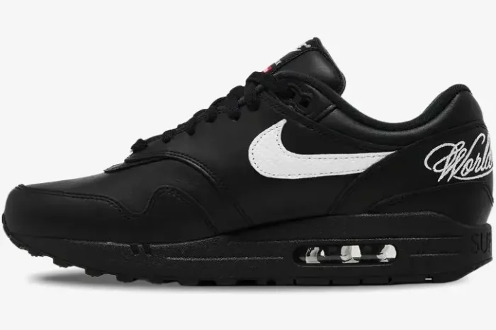 Side view of Nike Air Max 1 '87 SP x Supreme black leather sneaker with white swoosh and heel script. - SKU HF8813-001
