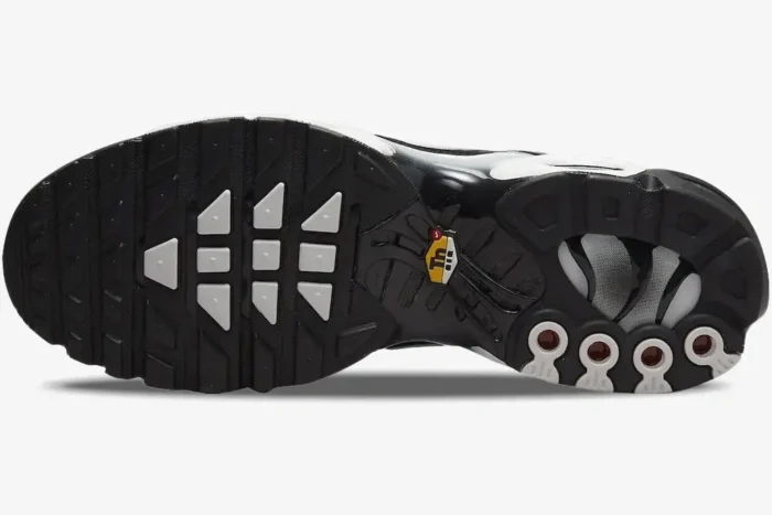 Bottom view of Nike Air Max Plus TN Black Metallic outsole with yellow Tn logo and red accents. - SKU DM0032-003