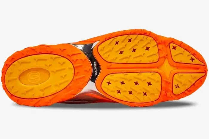 Bottom view of Nike Hot Step 2 x NOCTA orange sneakers showing the textured outsole and chrome midfoot plate. - SKU DZ7293-800