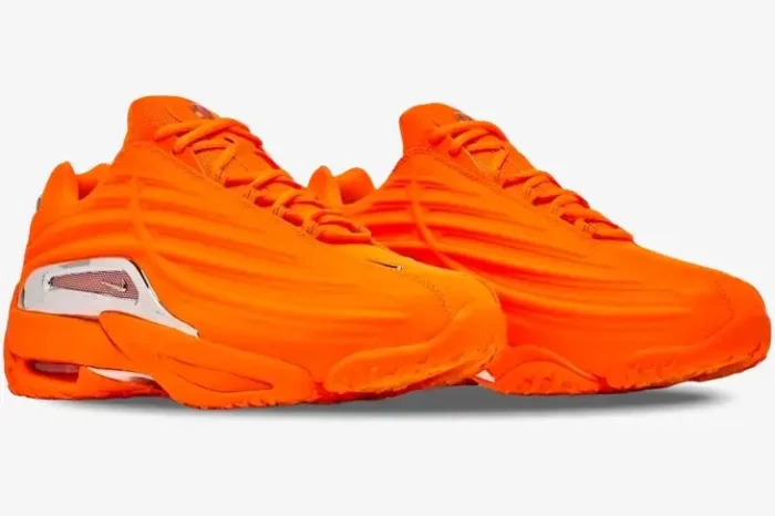 Nike Hot Step 2 x NOCTA sneakers in vibrant orange, side three-quarter view showing chrome heel accents. - SKU DZ7293-800
