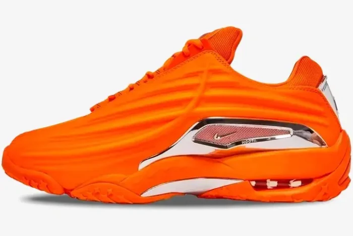 Side profile view of the vibrant Nike Hot Step 2 x NOCTA sneaker in bright orange with chrome accents. - SKU DZ7293-800