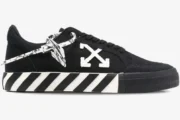 Side view of Off-White Low Vulcanized black canvas sneakers with white arrow logo and striped sole. - SKU OWIA272C99LEA0011001