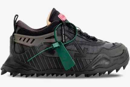 Side profile of the Off-White ODSY-1000 'Black' 2023 sneaker featuring a chunky spiked sole and green zip tie. - SKU OWIA180C99FAB001-1000