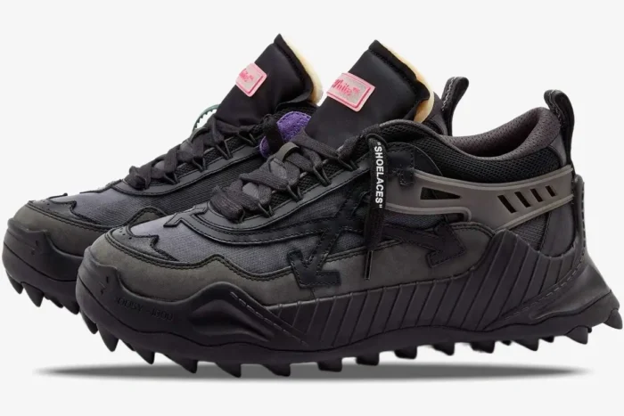 Side profile of Off-White ODSY-1000 Black sneakers with chunky spiked soles and pink tongue labels. - SKU OWIA180C99FAB001-1000