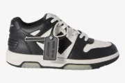 Side profile of Off-White Out Of Office sneakers in white and black leather with a signature zip tie tag. - SKU OMIA189C99LEA0070110
