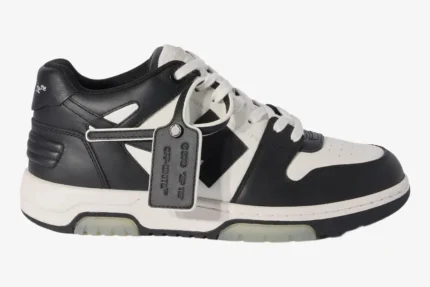 Side profile of Off-White Out Of Office sneakers in white and black leather with a signature zip tie tag. - SKU OMIA189C99LEA0070110