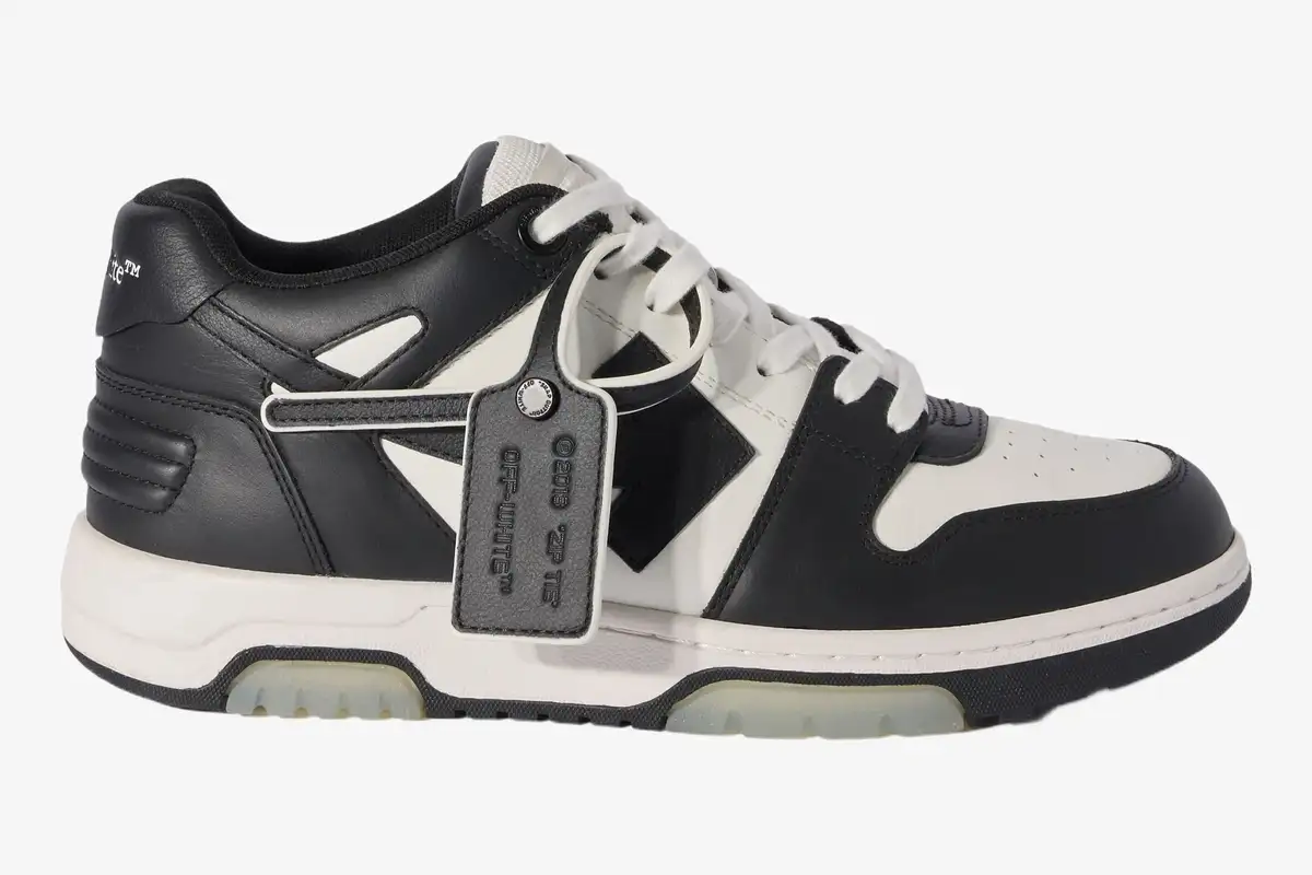 off-white-out-of-office-white-black-side-view-omia189c99lea0070110-158-805 Side profile of Off-White Out Of Office sneakers in white and black leather with a signature zip tie tag. - SKU OMIA189C99LEA0070110