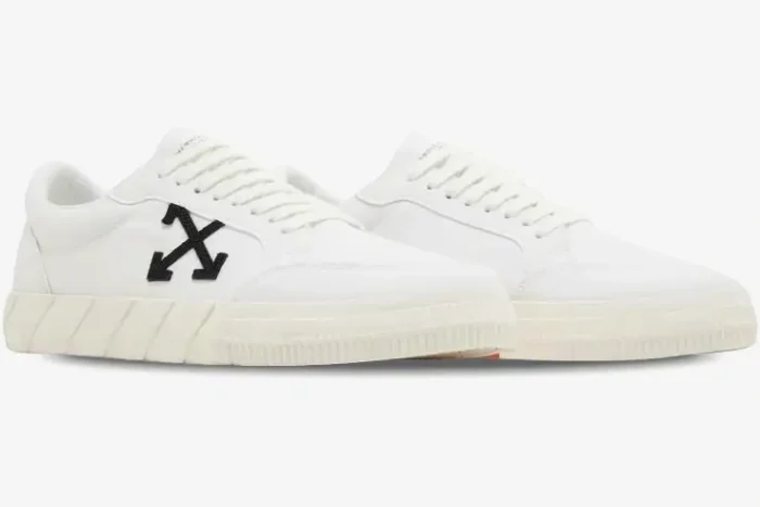 Side view of Off-White Vulcanized Low Canvas sneakers in white with a black arrow logo. - SKU OMIA085C99FAB0070110
