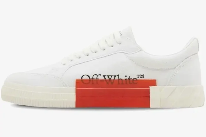 Side view of Off-White Vulcanized Low Canvas sneakers in white with red midsole detail and black logo. - SKU OMIA085C99FAB0070110