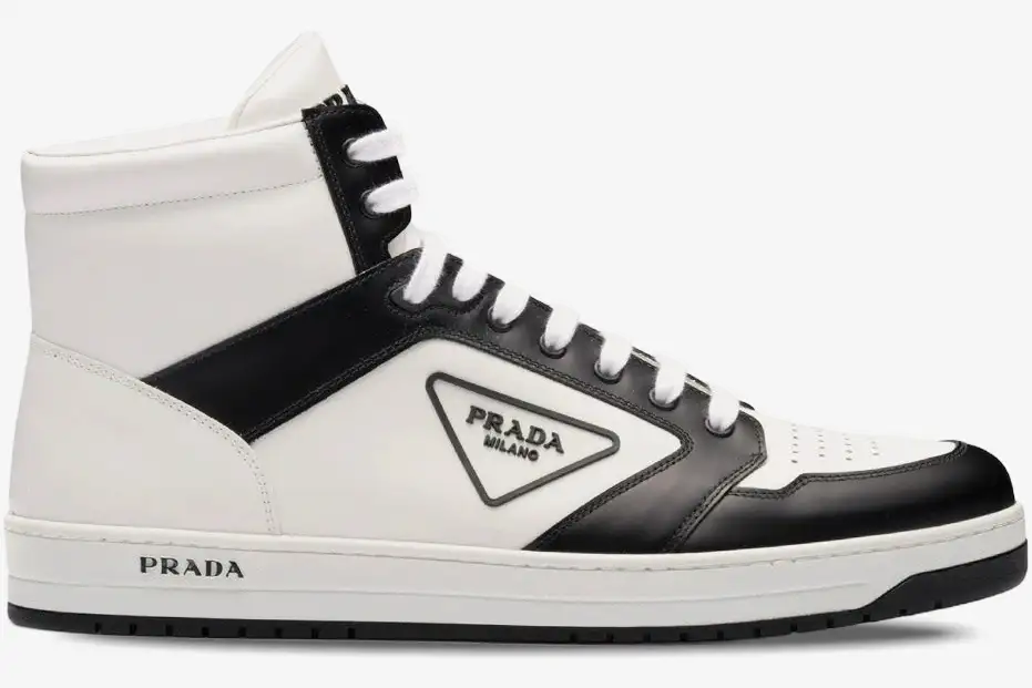 prada-district-high-top-white-black-side-view-2te182-3lj6-f0964-864-269 Side view of Prada District high-top leather sneakers in a white and black colorway. - SKU 2TE182-3LJ6-F0964
