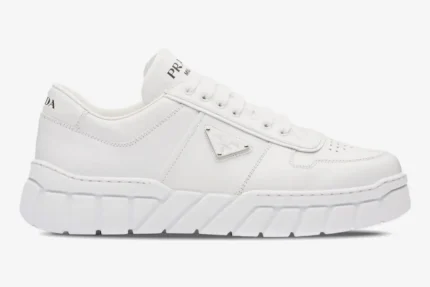 Side view of white Prada low-top sneakers with a chunky geometric tread sole. - SKU 2EE3783LJ6F0009
