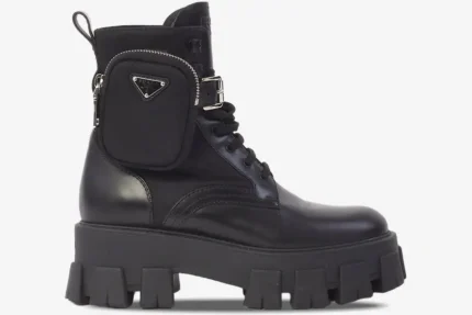 Side view of black Prada Monolith leather boots with a chunky lug sole and detachable nylon pouch. - SKU 1T255M_3L09_F0002_F_055