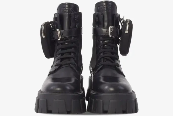 Front view of black Prada Monolith leather boots with chunky lug soles and detachable side pouches. - SKU 1T255M_3L09_F0002_F_055